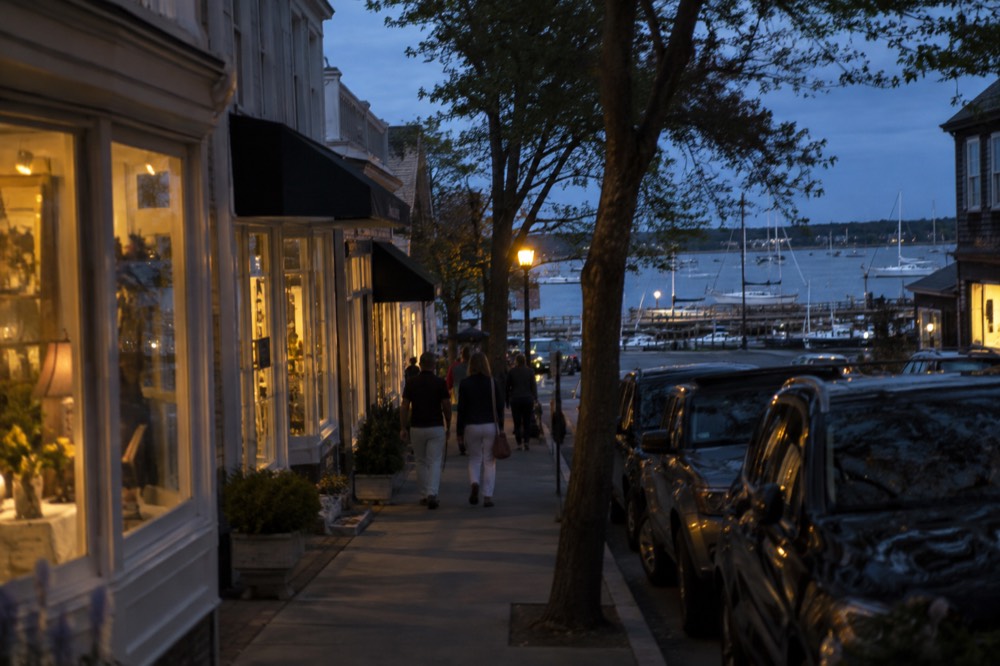 Sag Harbor main street with shops and boats visible in the harbor beyond