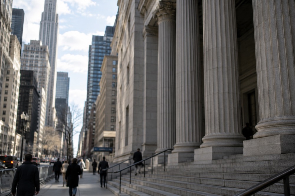 The stone facade and columns of a New York courthouse on a bright morning