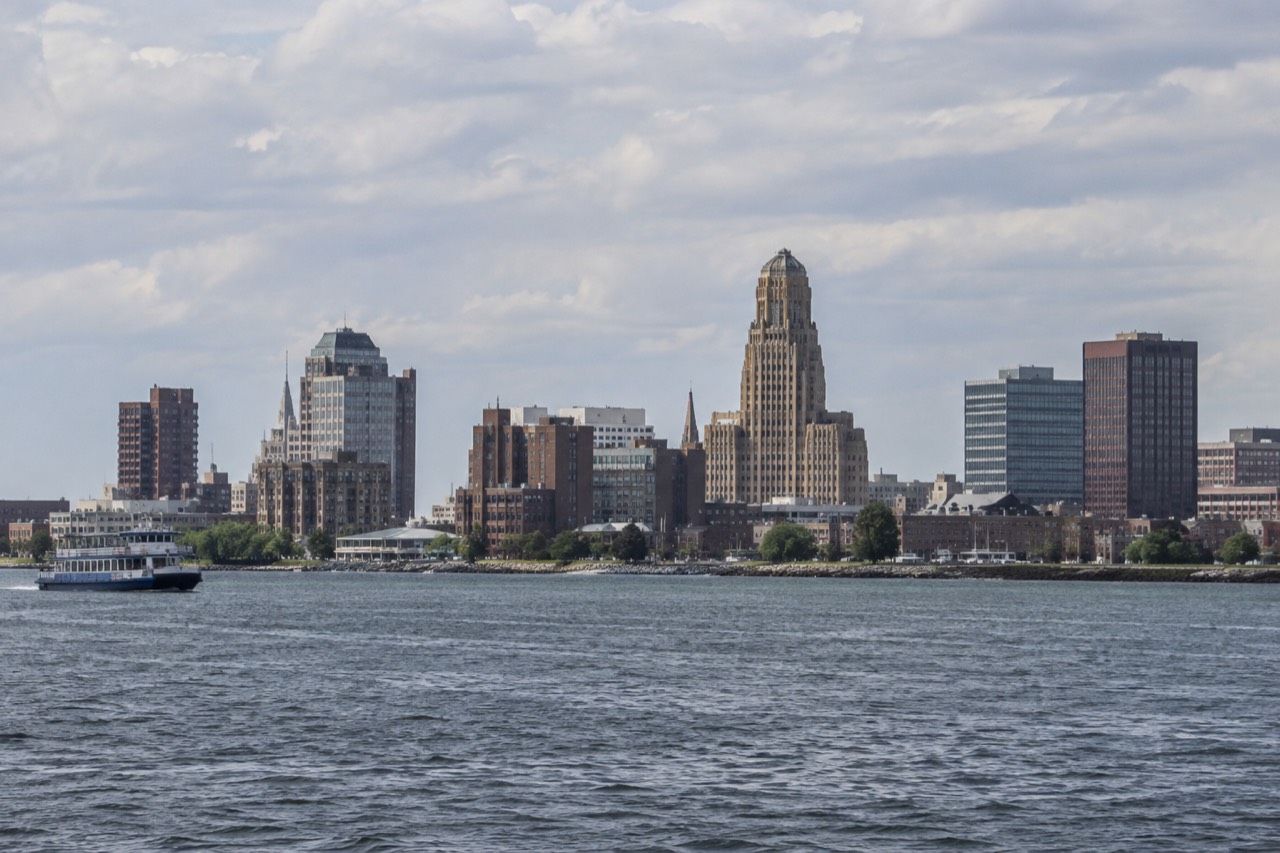 The Buffalo skyline and Lake Erie waterfront seen from across the water on a clear afternoon