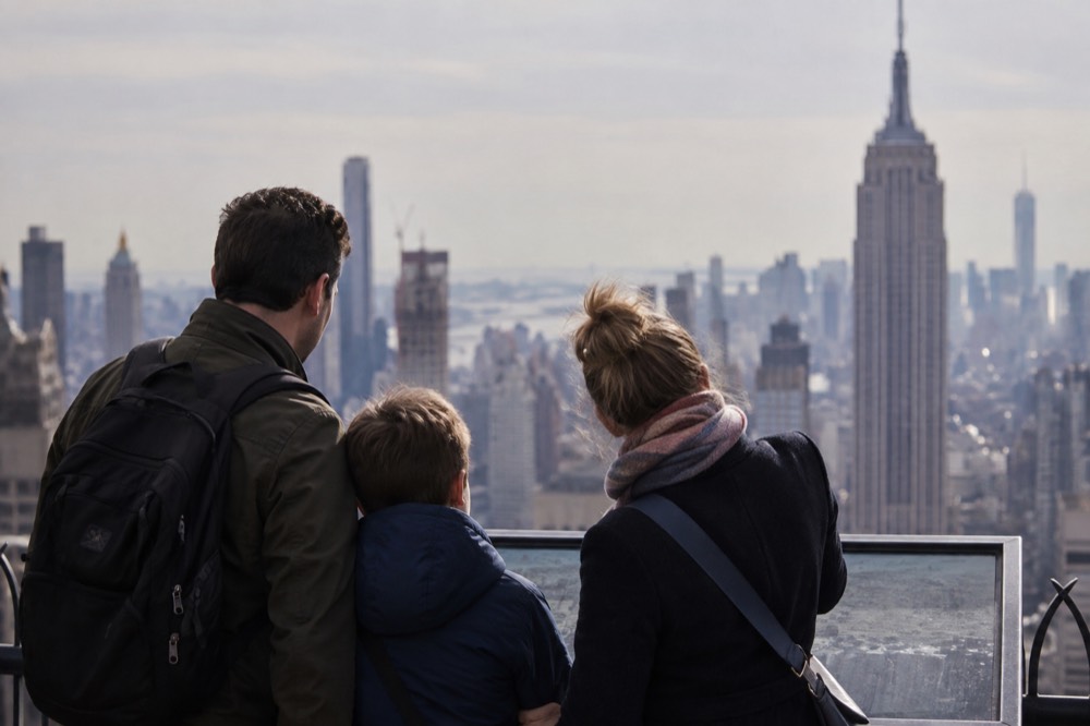 A family studying a city map on a bench outside a Manhattan museum entrance