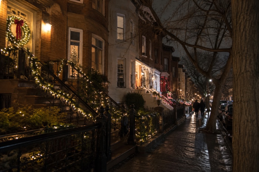 Festive holiday lights and decorations on residential houses in a Brooklyn neighborhood at night