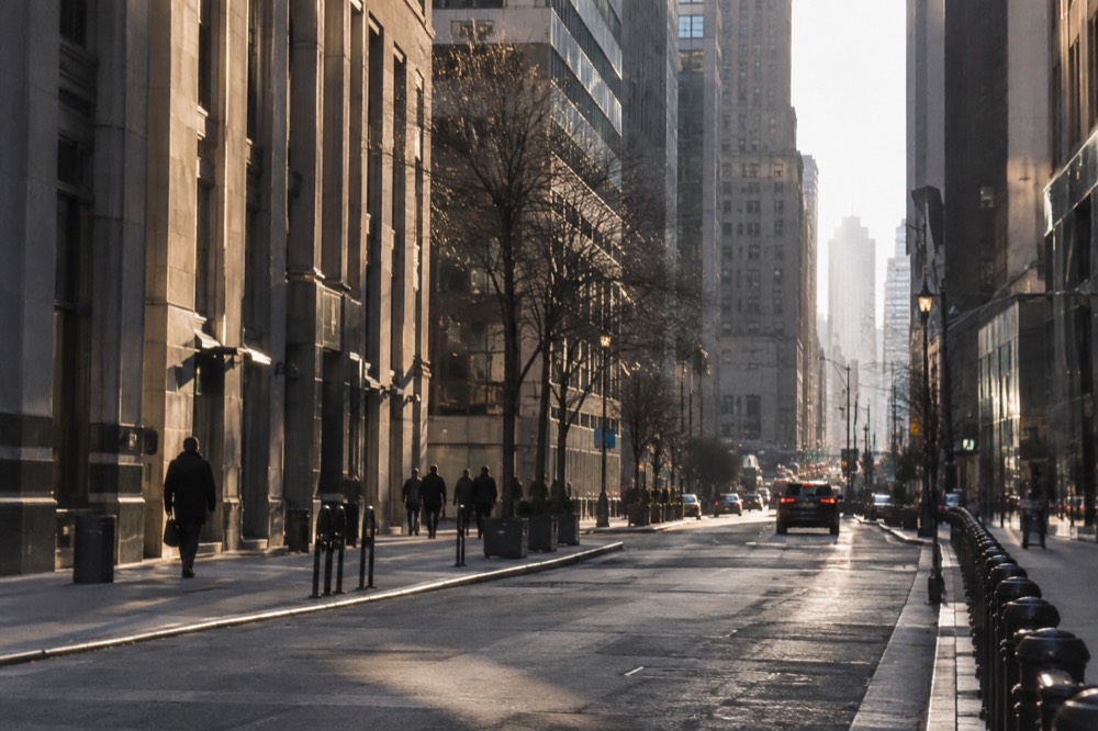 A quiet weekend morning on a Financial District street with tall office towers on both sides