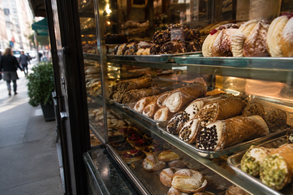Cannoli and Italian pastries in a bakery display case
