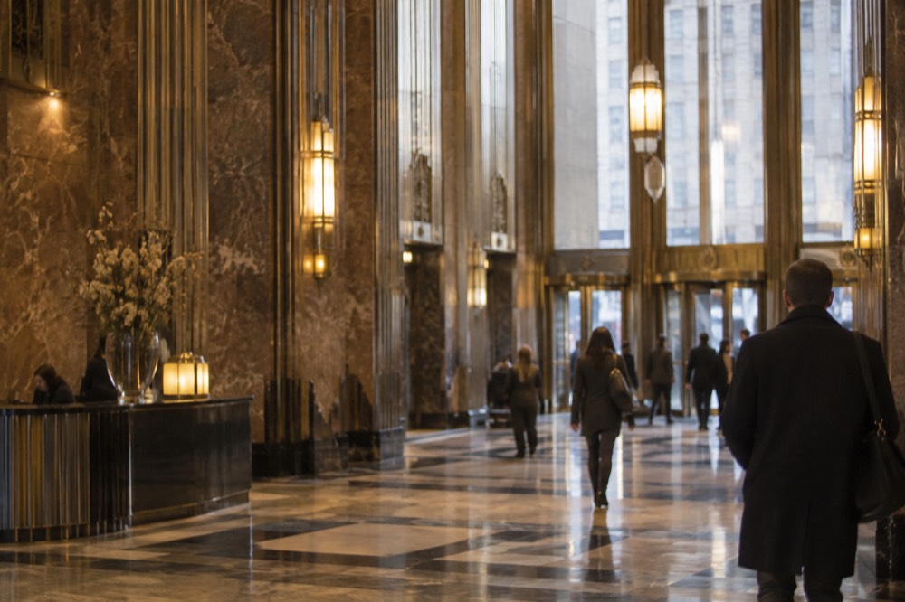 An Art Deco lobby with brass fixtures and marble walls inside a Midtown landmark