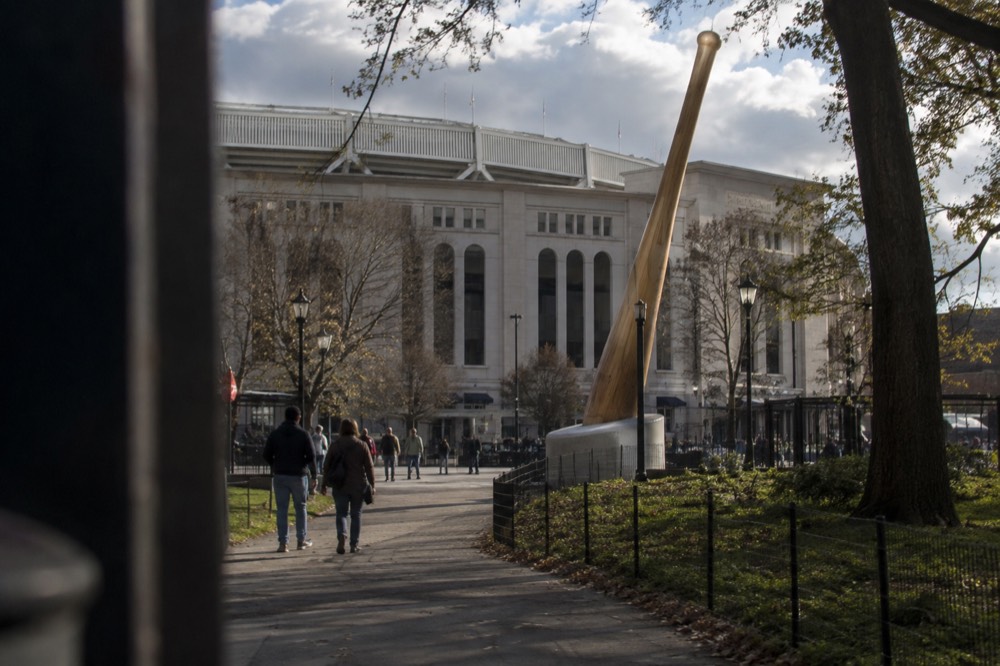 A stadium exterior with a large bat-shaped structure beside it