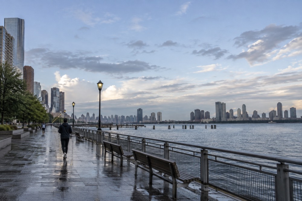 Walkway beside the Hudson River with benches and railings facing the water