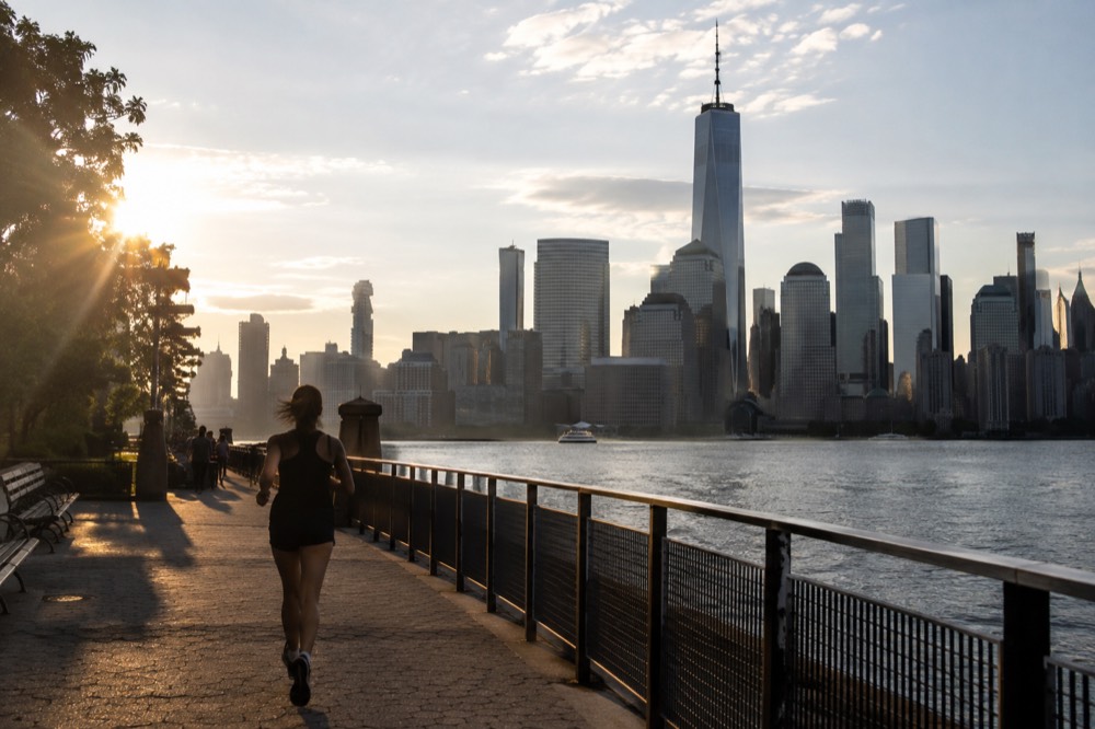 The Lower Manhattan skyline seen from the harbor, with One World Trade Center rising above the older towers