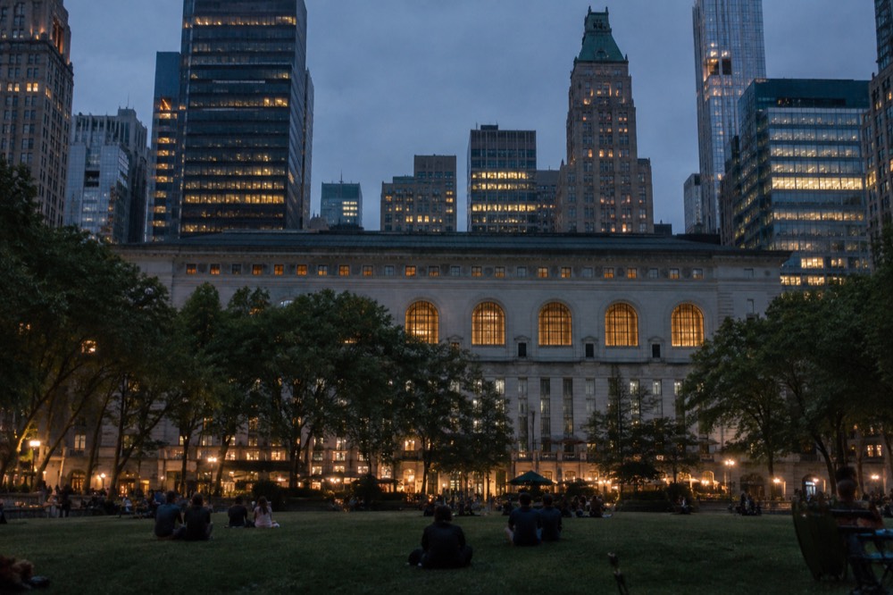 View across the Bryant Park lawn toward the rear facade of the New York Public Library