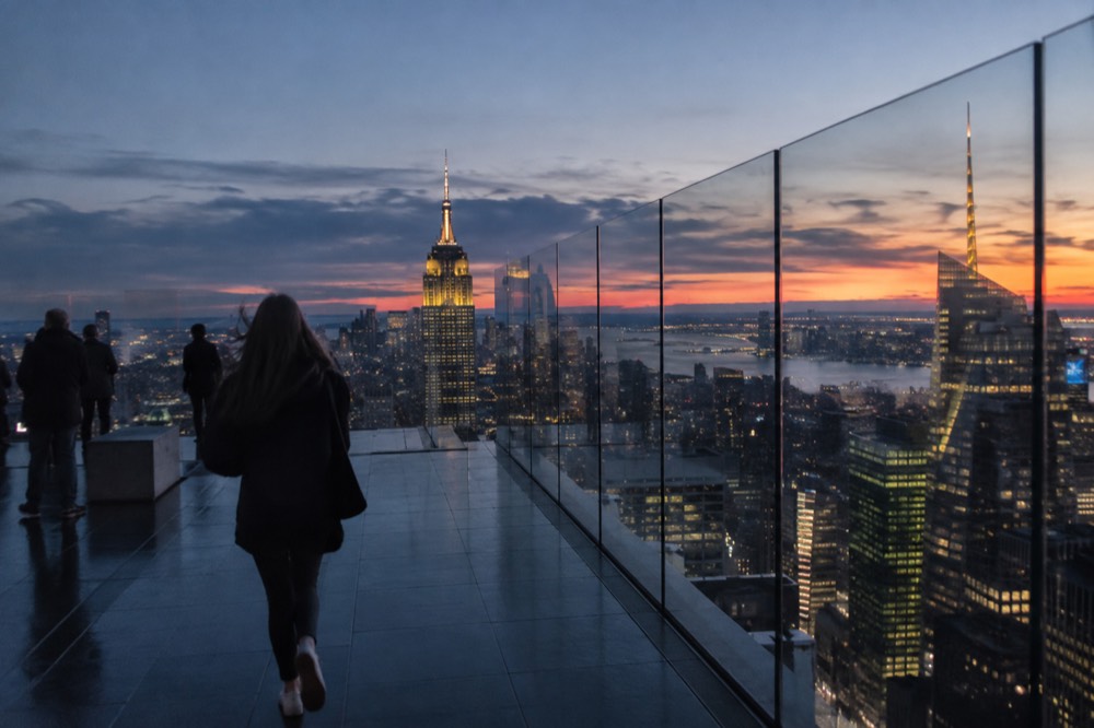 Sunset light falling across the Manhattan skyline seen from a high observation floor