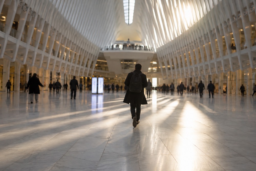 Morning light streaming through the skylight of The Oculus onto the marble floor