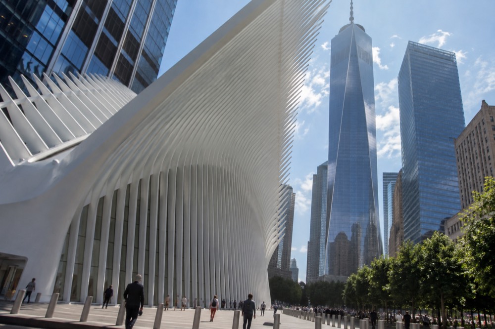 The exterior ribs of The Oculus seen from the street with One World Trade Center behind