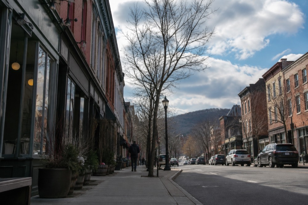 A brick main street with small shops and diners, quiet in the morning