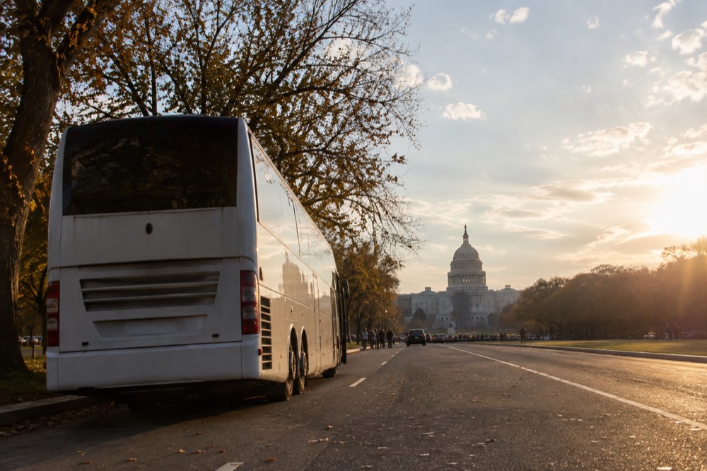 Coach parked near the National Mall in Washington DC with the Capitol building in the distance