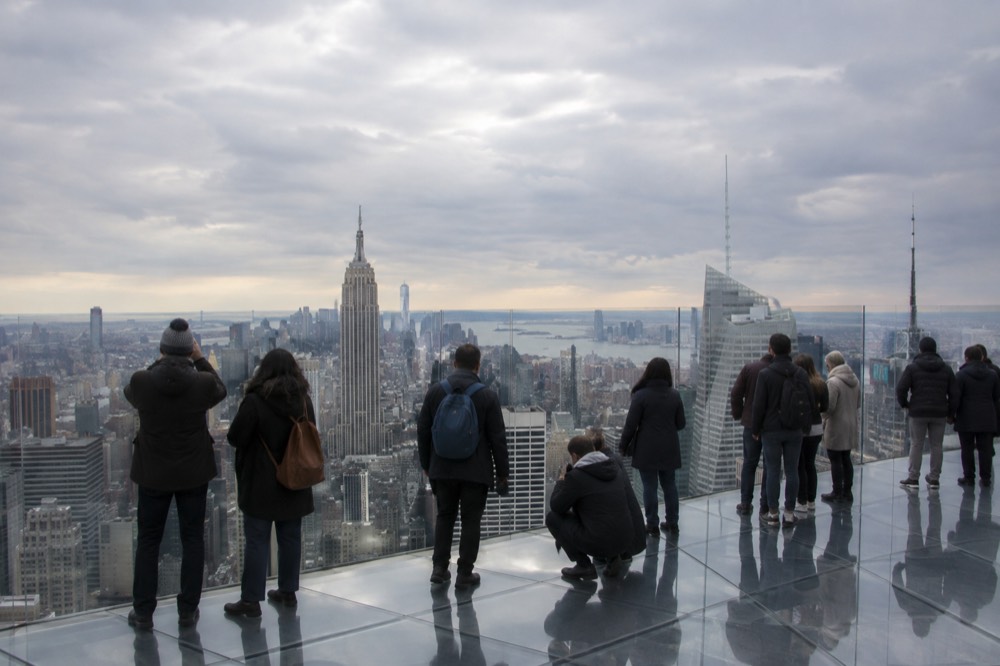 A glass-floored observation deck overlooking the Manhattan skyline