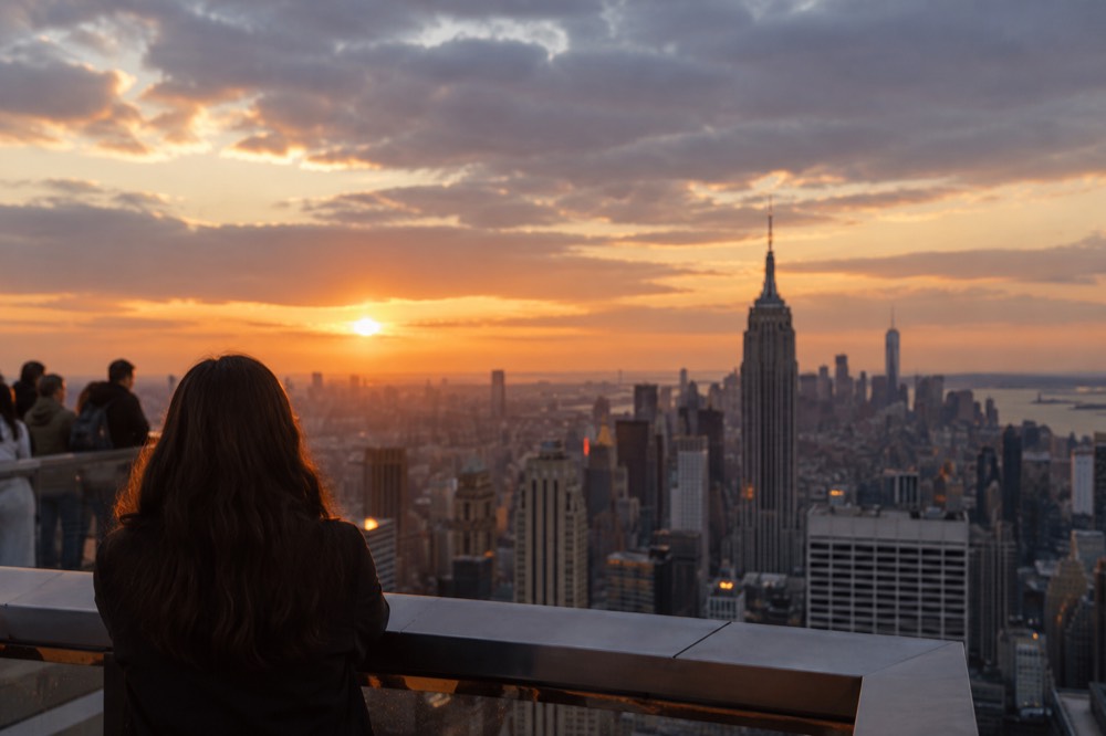 The Manhattan skyline at sunset viewed from an observation deck with autumn haze