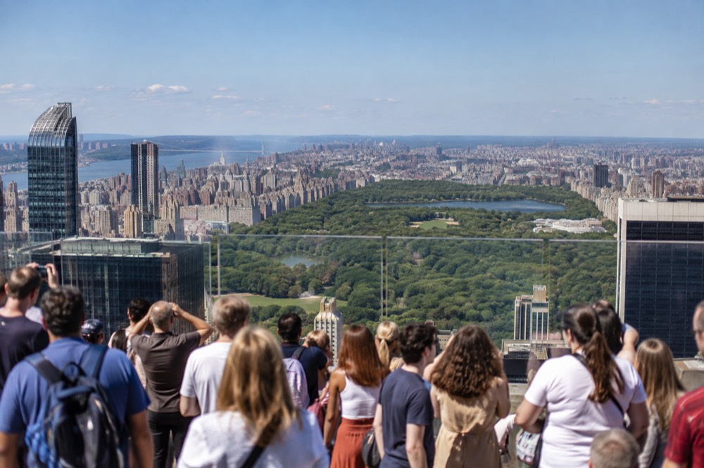 Crowds on the observation deck at Top of the Rock with Central Park behind them