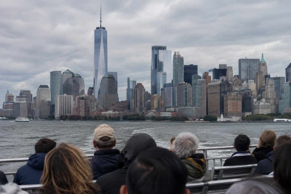 A Circle Line sightseeing boat passing Lower Manhattan on the Hudson River