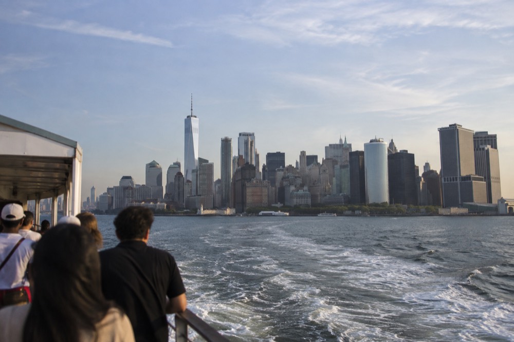 The Manhattan skyline seen from a harbor cruise boat on a clear afternoon