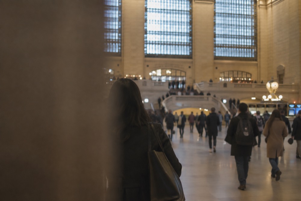 The main concourse of a busy Manhattan train station with departure boards and crowds