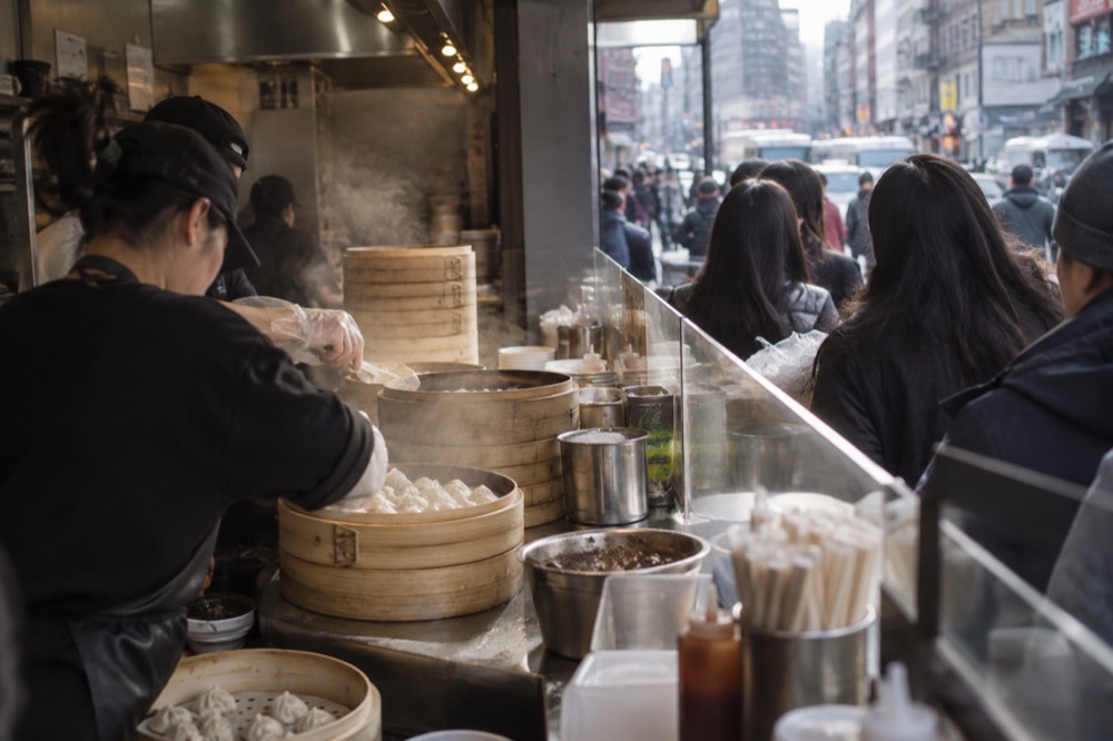 Dumplings being served at a busy counter in Chinatown