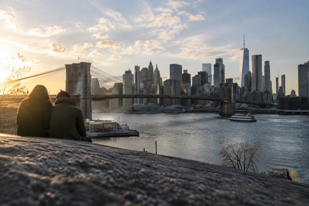 Lower Manhattan skyline and New York Harbor seen from above with the Brooklyn Bridge crossing the East River