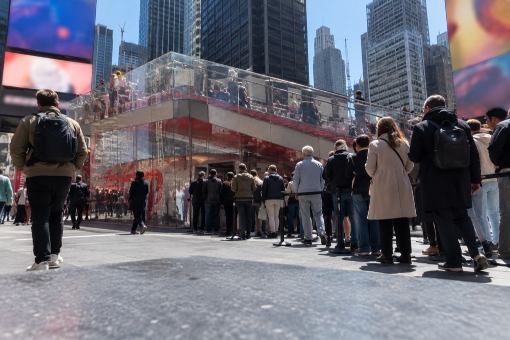 The illuminated TKTS booth in Duffy Square with a queue of theatre-goers along the steps