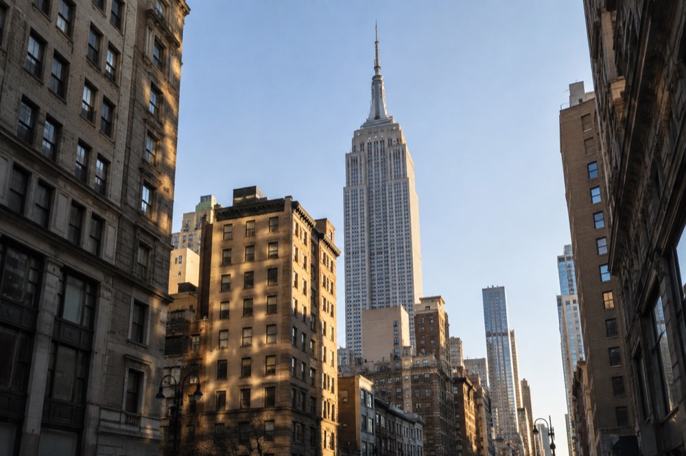 Looking up at the Empire State Building from a Midtown street corner