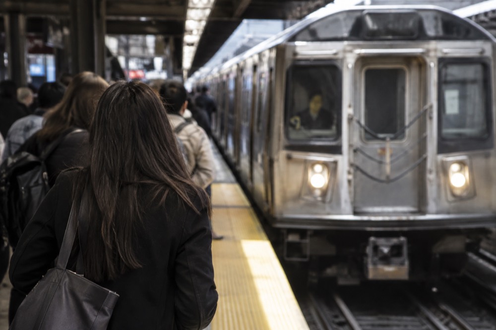 Crowds on a quiet morning platform as a subway train arrives in Manhattan